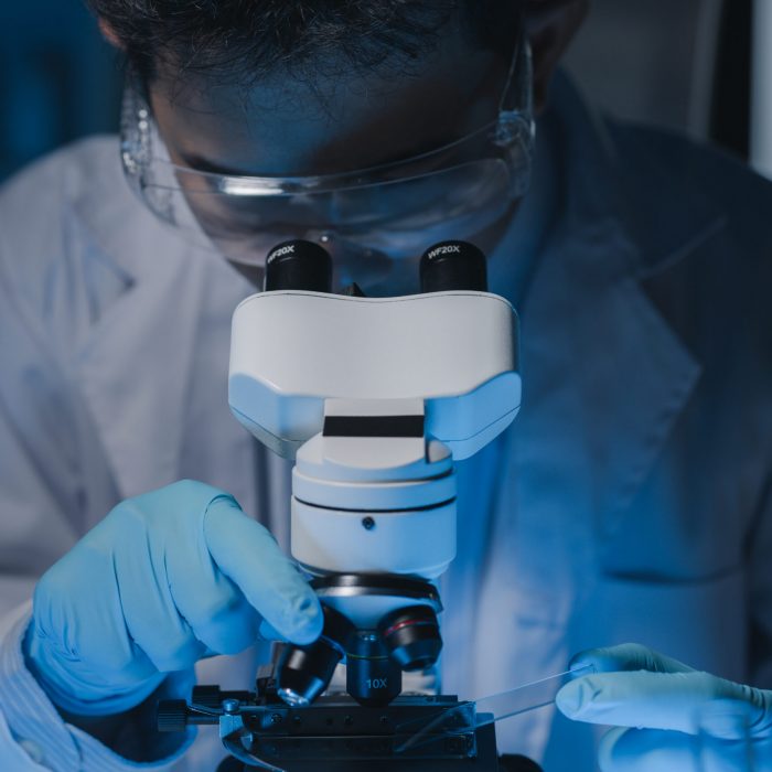 A scientist is studying samples using a microscope to study and develop the field of microbiology, Microscopes are used by researchers to study chemotherapy.